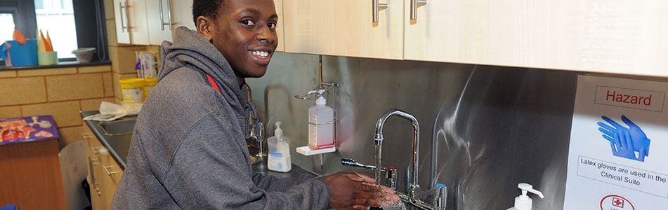 student washing their hands